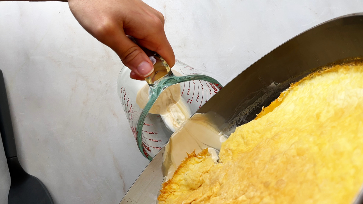 Pouring buttermilk out of a fry pan.