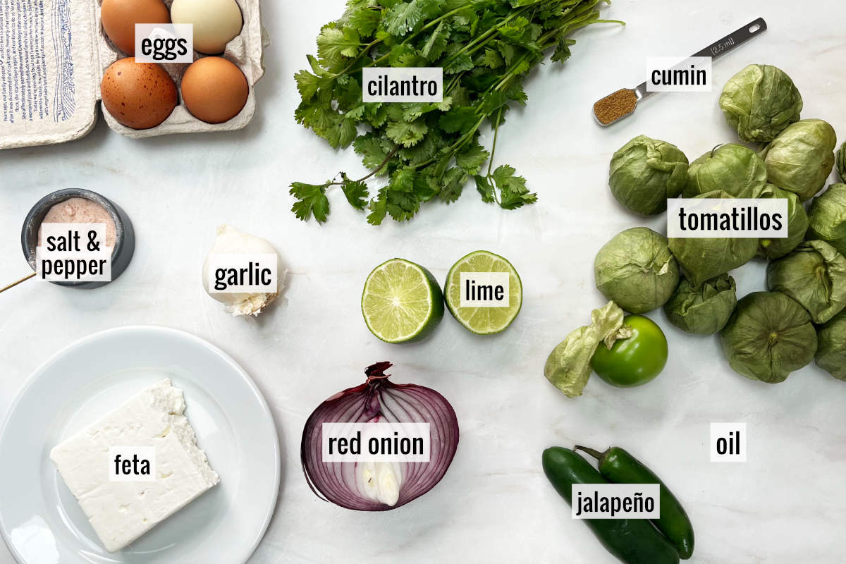 Tomatillos and other ingredients on a countertop.