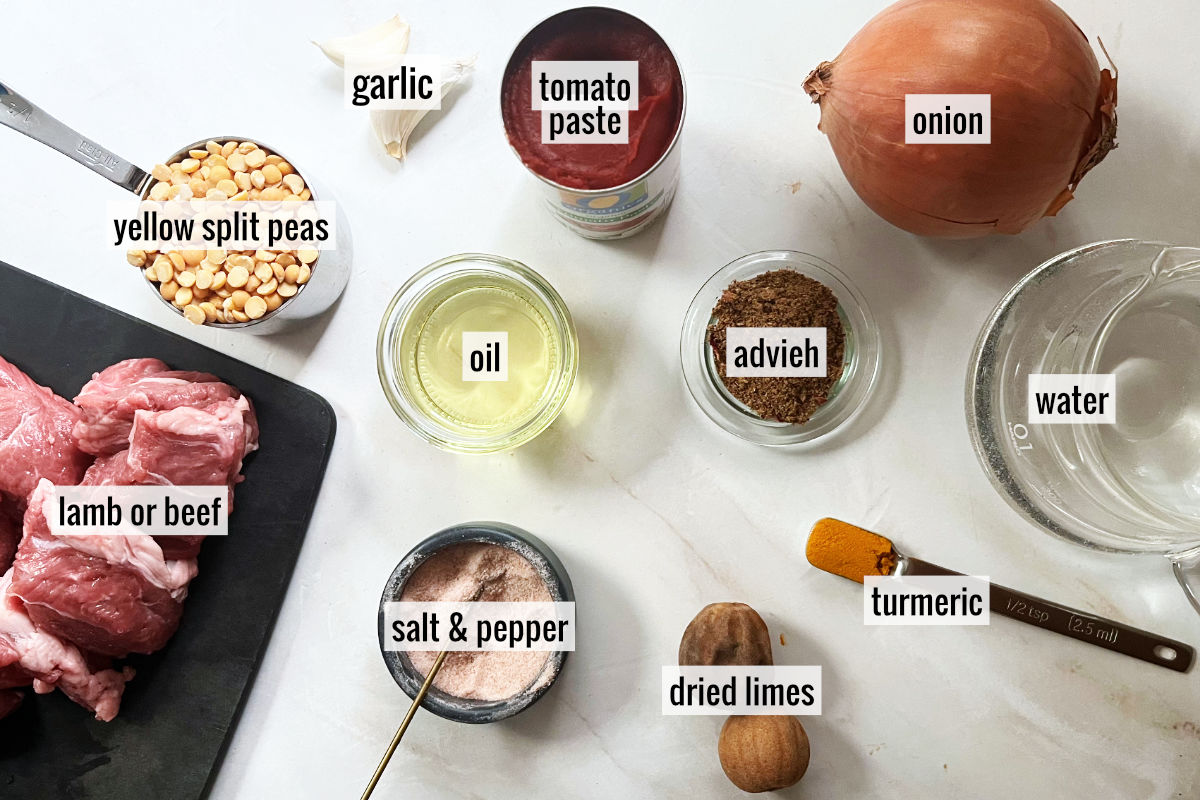 Meat and other stew ingredients on a white countertop.