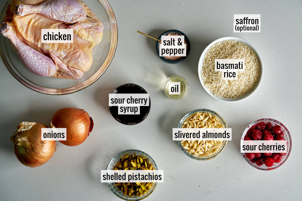 Cherries, chicken, and other ingredients on a countertop.