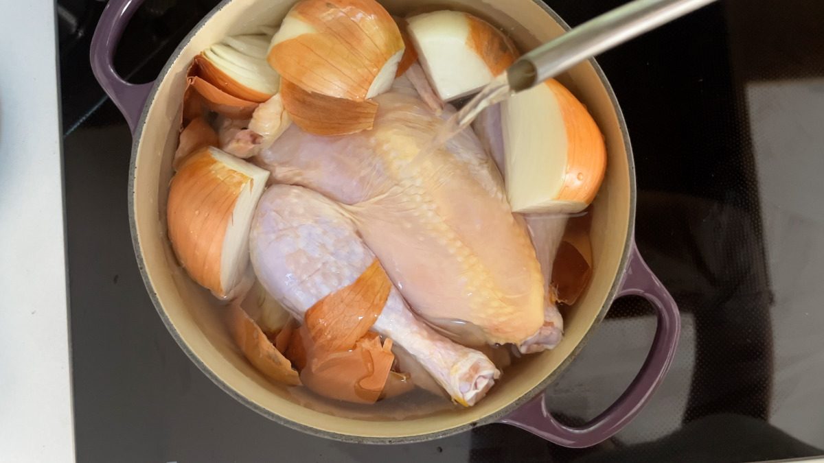 Chicken in a pot with onions.