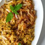 Eggplant dip on a plate with mint garnish.