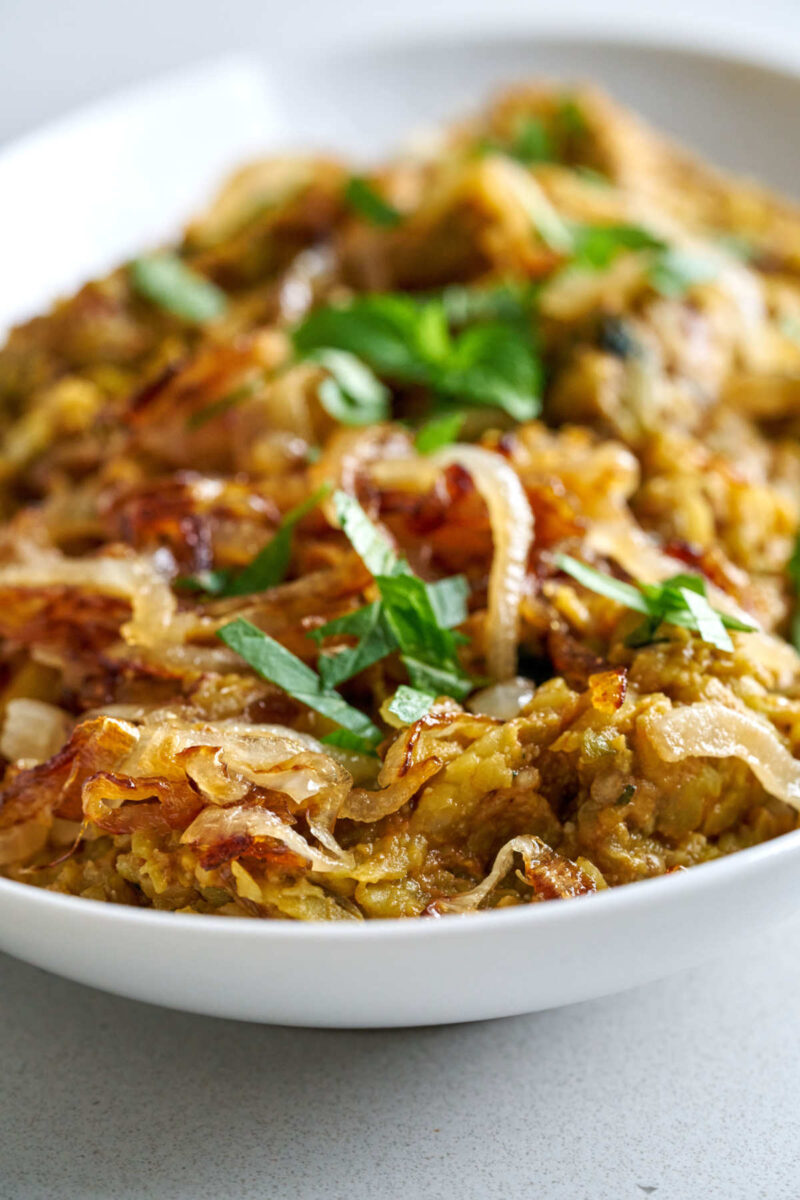 Eggplant dip with onions on a plate.