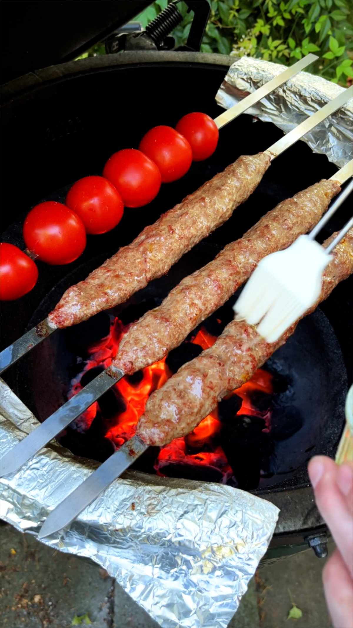 Basting kabobs on a grill.