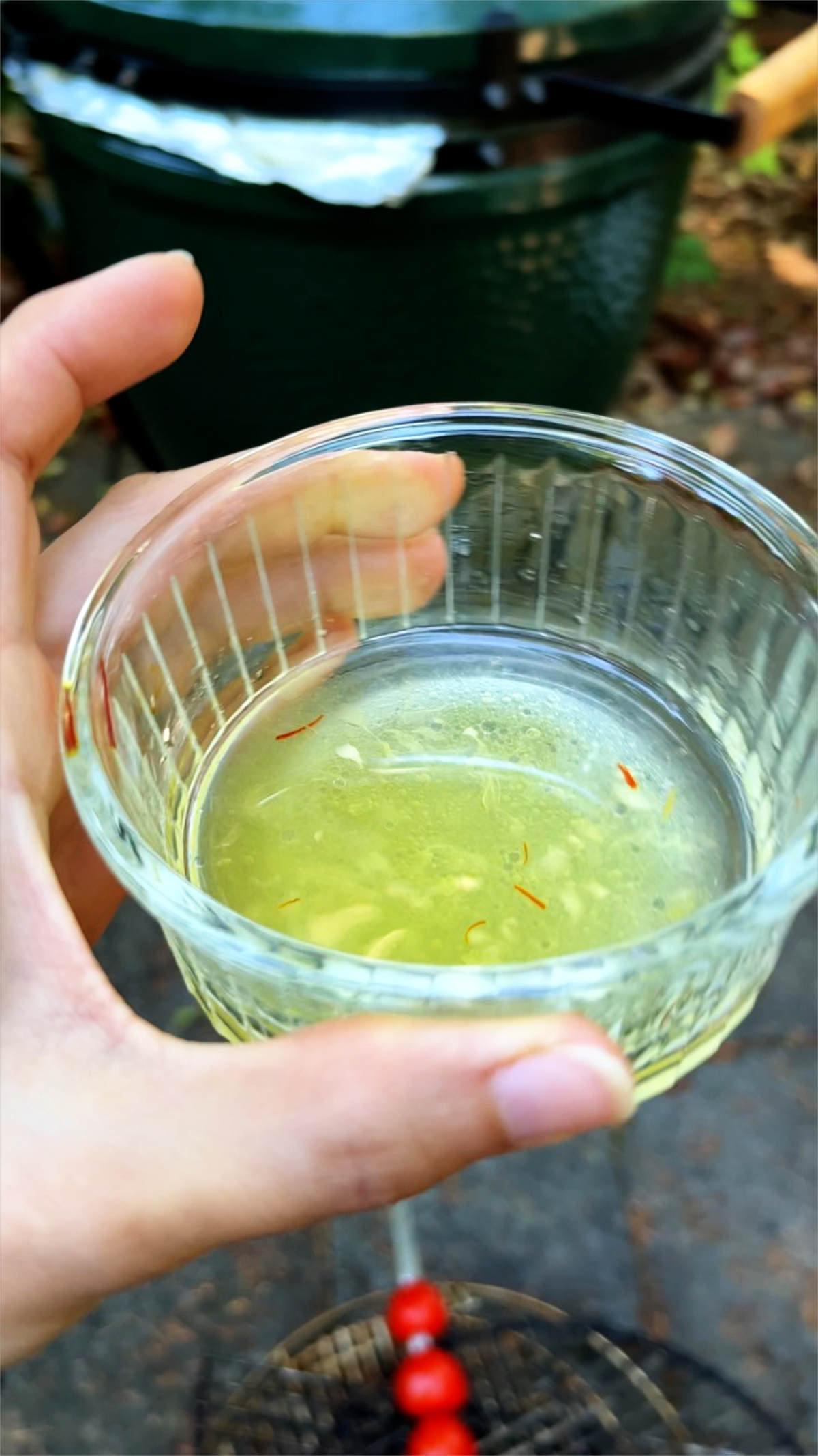 Yellow juice in a glass ramekin.