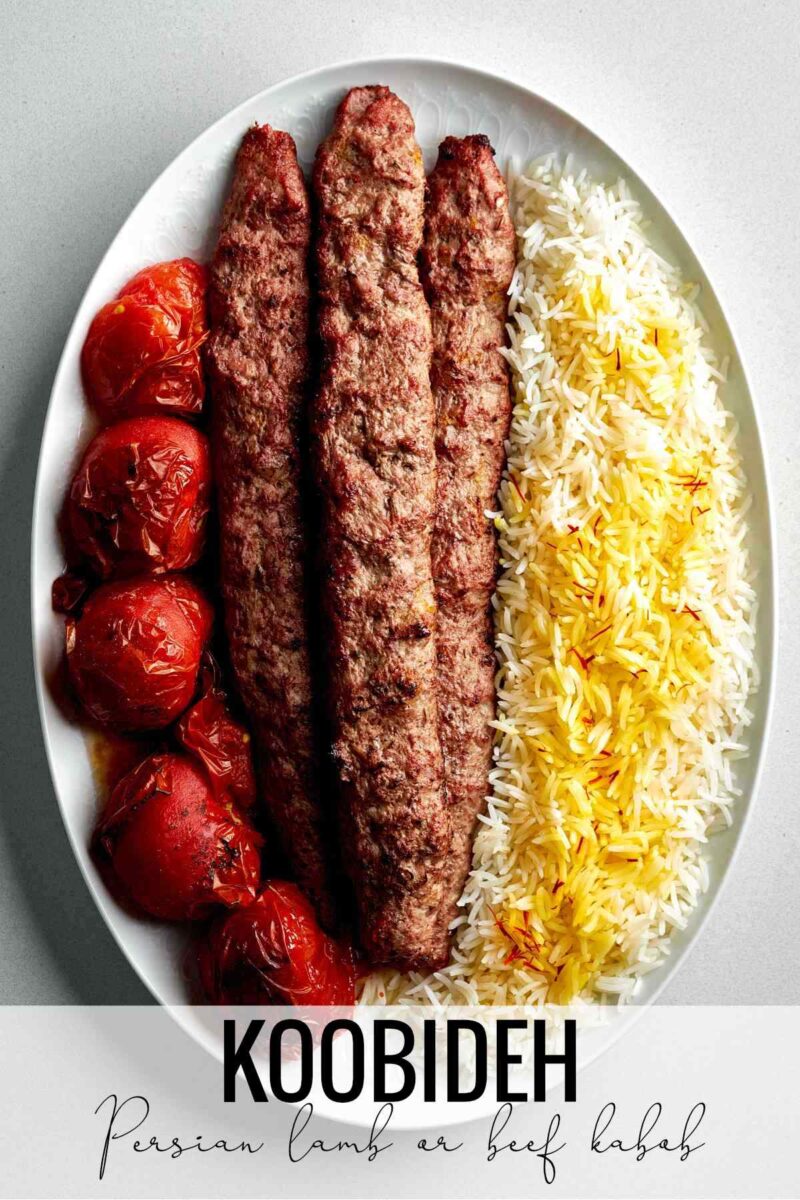 Meat kabobs on a plate with tomatoes and rice with title text.