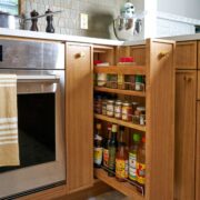 Kitchen spice rack pull out next to oven.