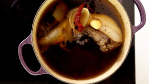 Beef tongue cooking in a pot.