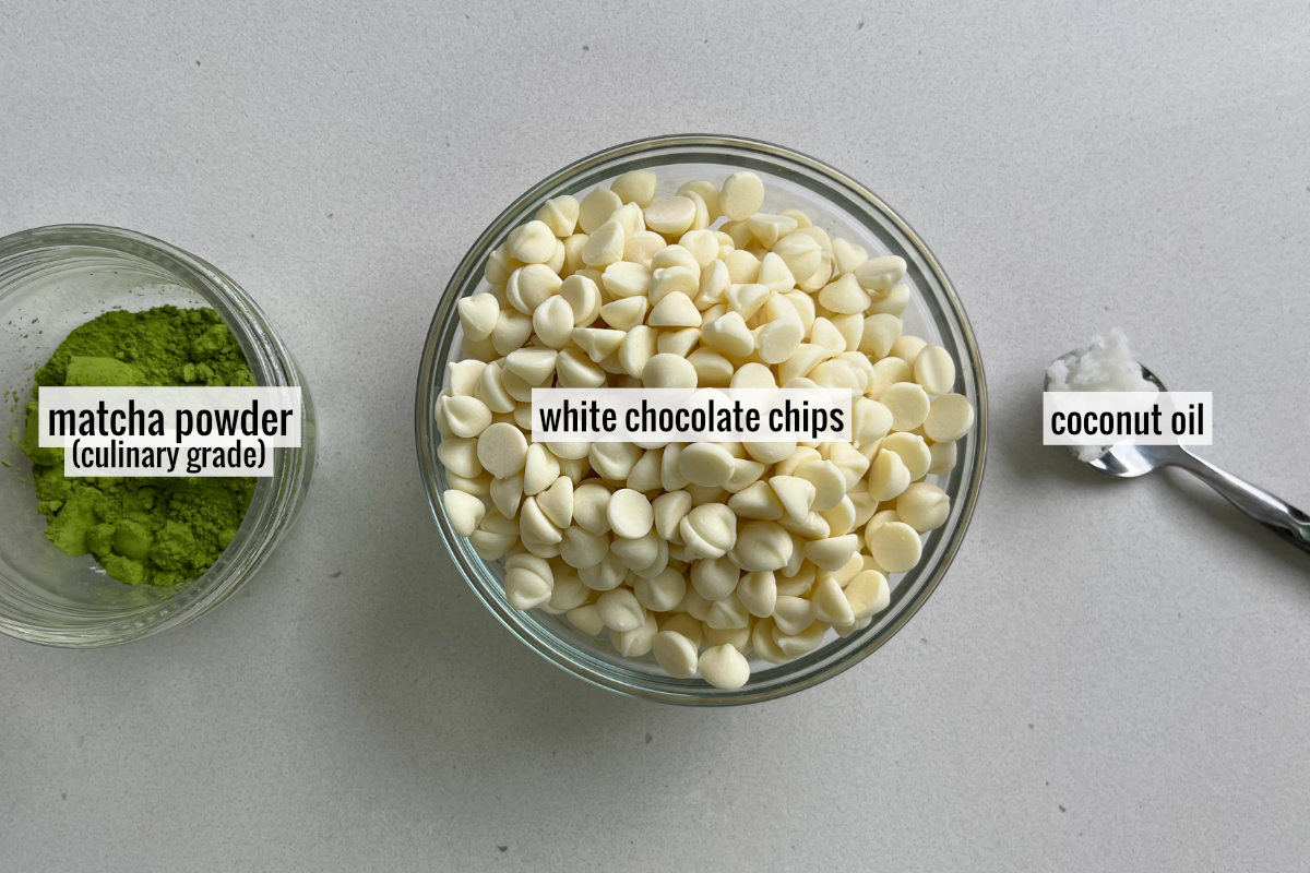 White chocolate chips and matcha on a countertop.