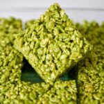 Green rice crispy treats in a baking dish.