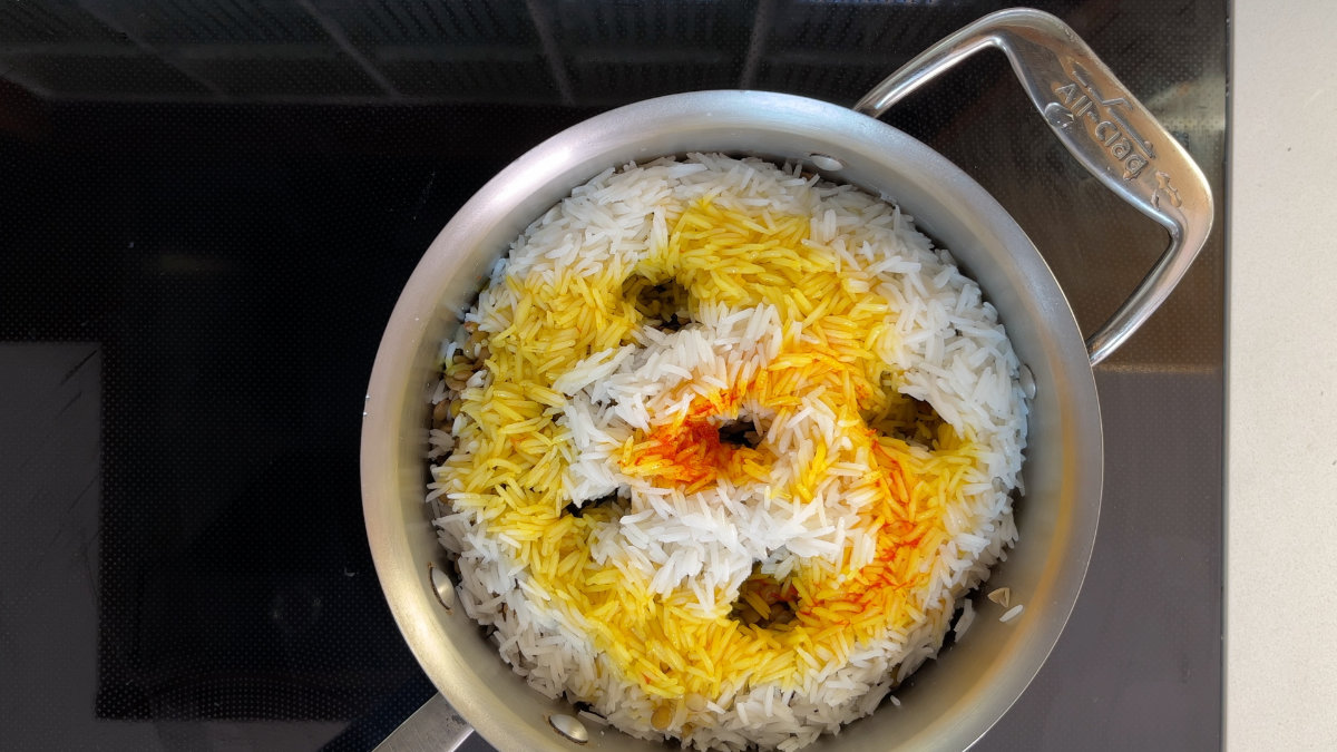 Saffron poured over rice with steam holes in it.