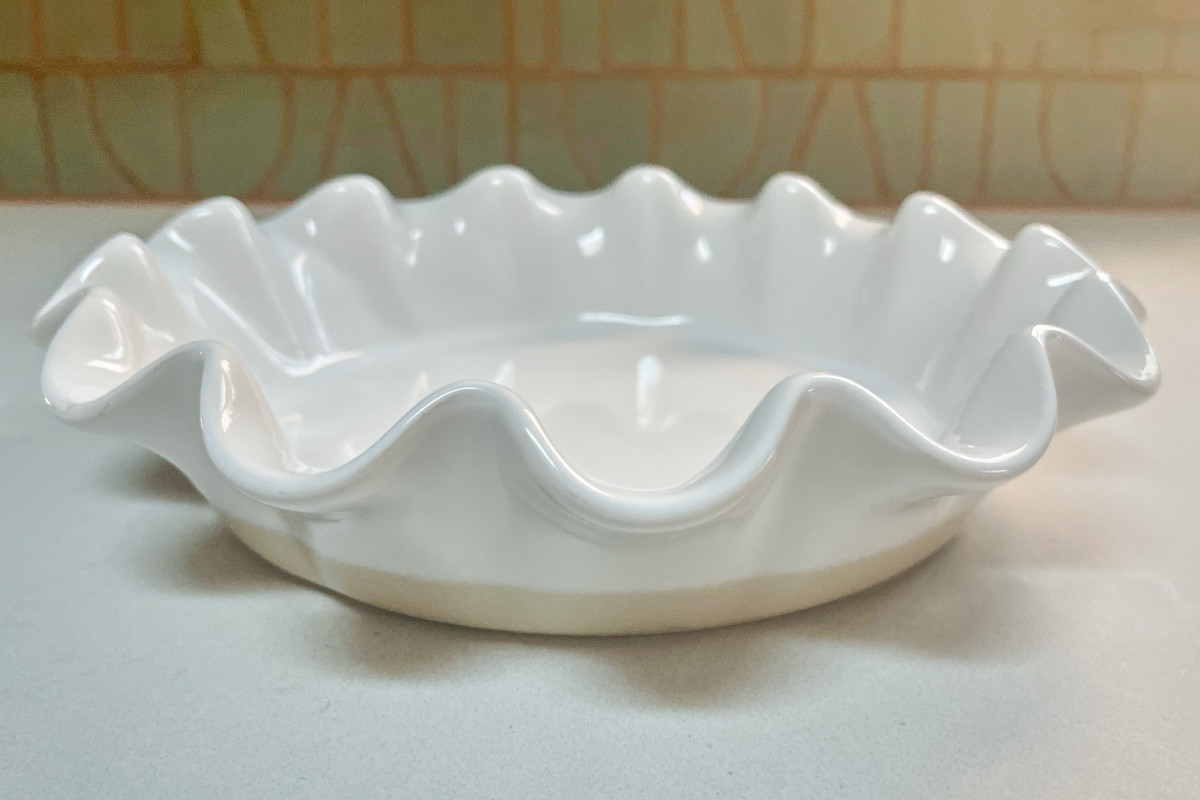 Ruffled pie dish on a countertop.