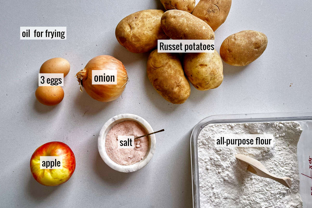 Potatoes and other latke ingredients on a countertop.