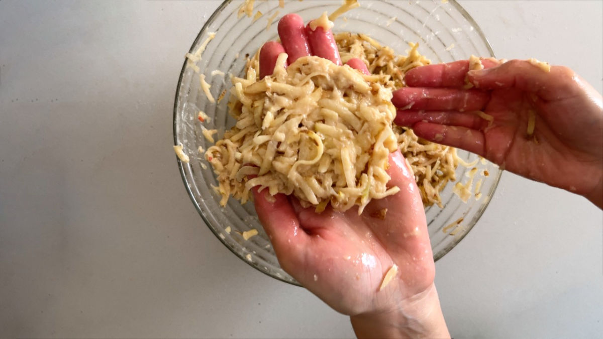 Grated potato patty in a hand.