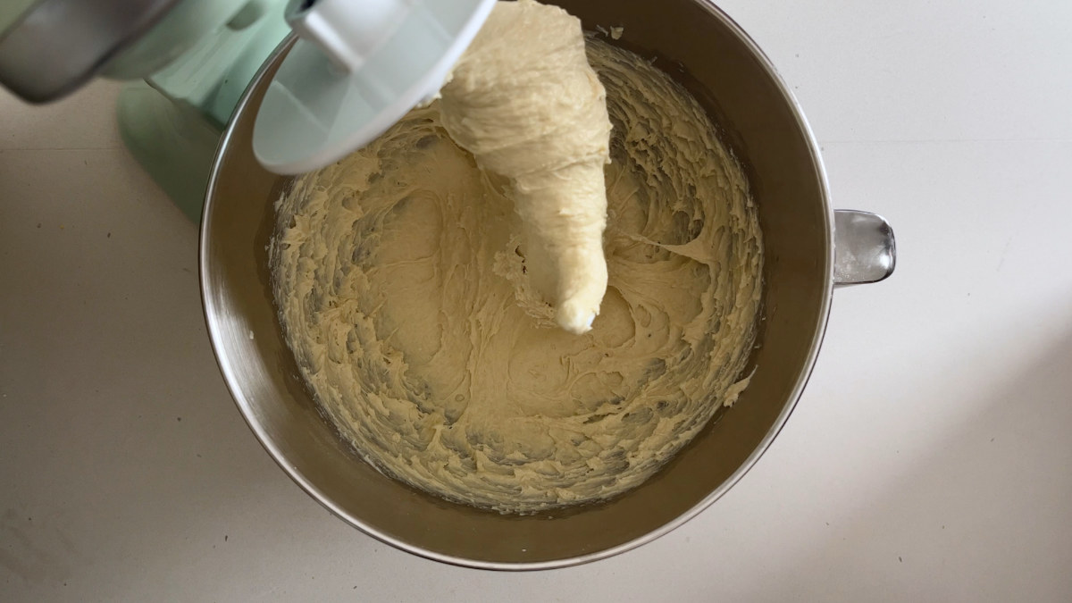 Bread dough in the bowl of a stand mixer.