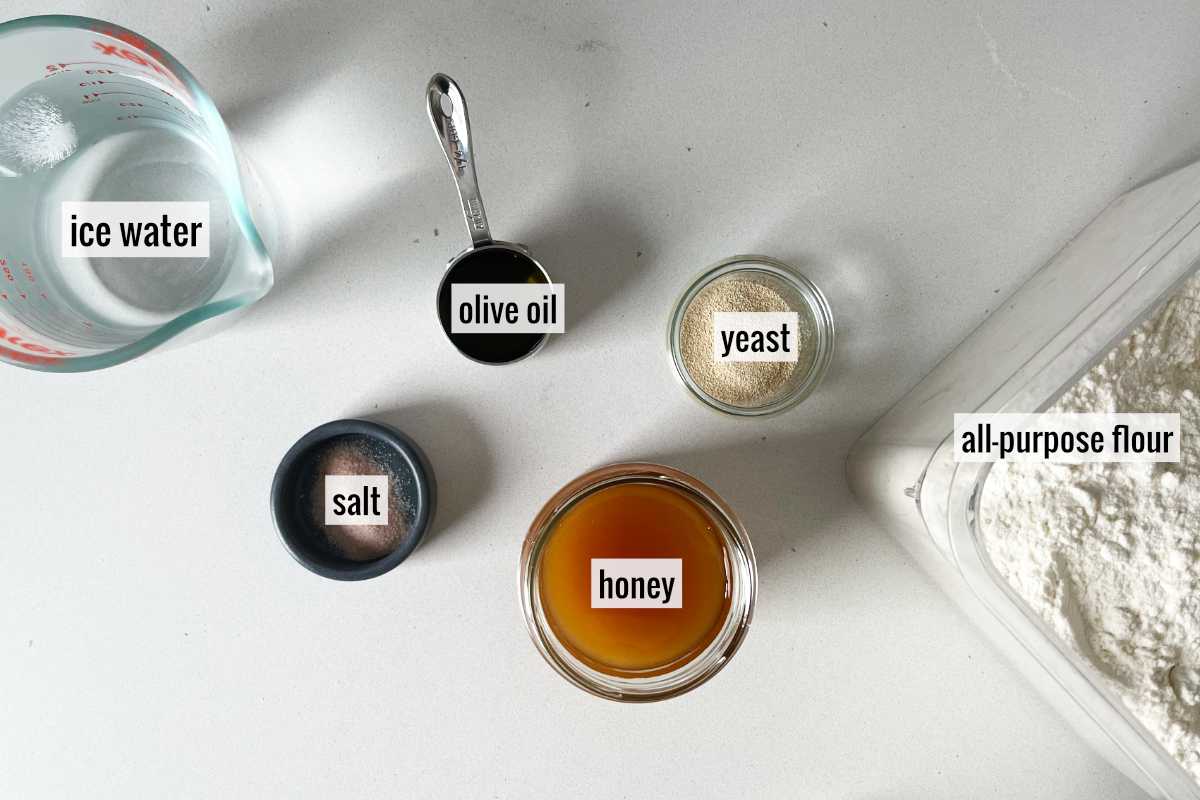 Flour and other ingredients to make pita on a countertop.