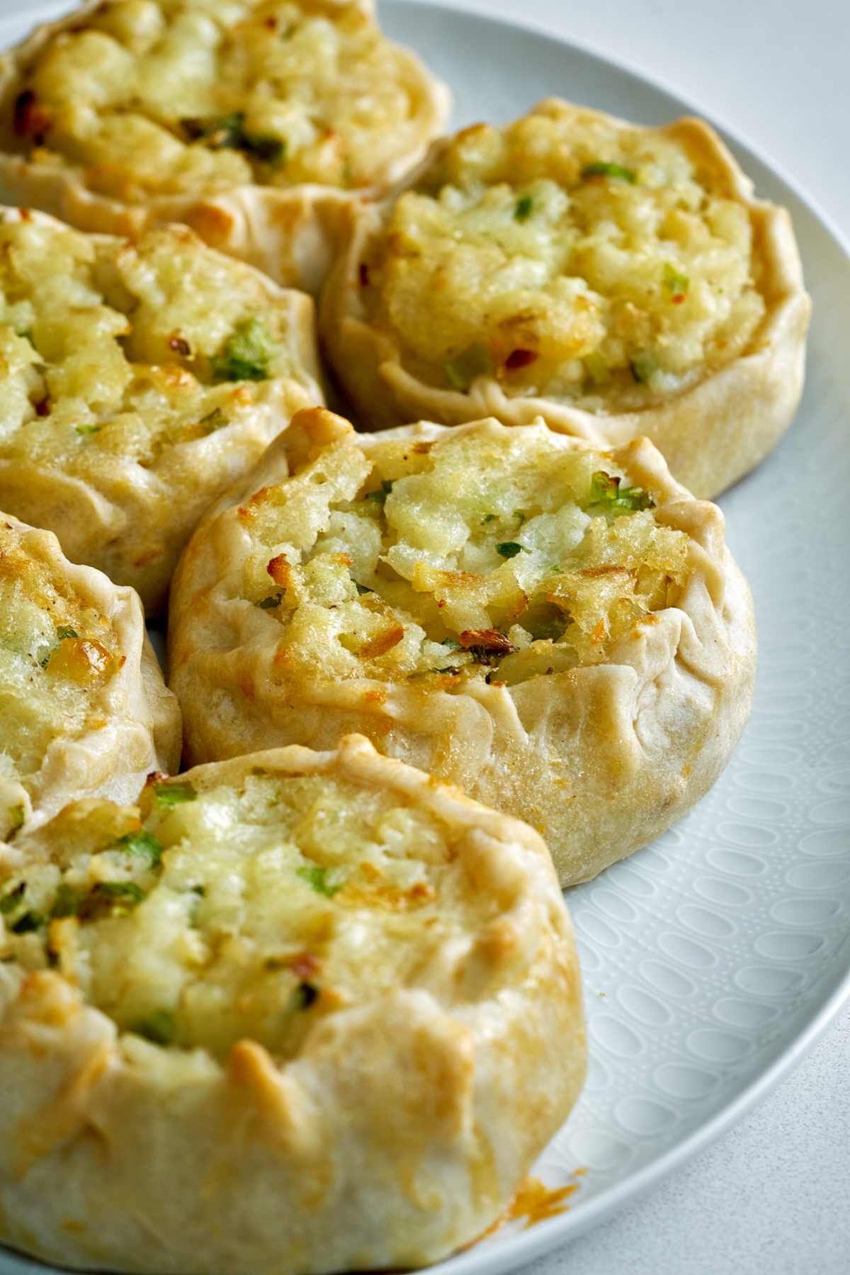 Plate full of potato knishes.