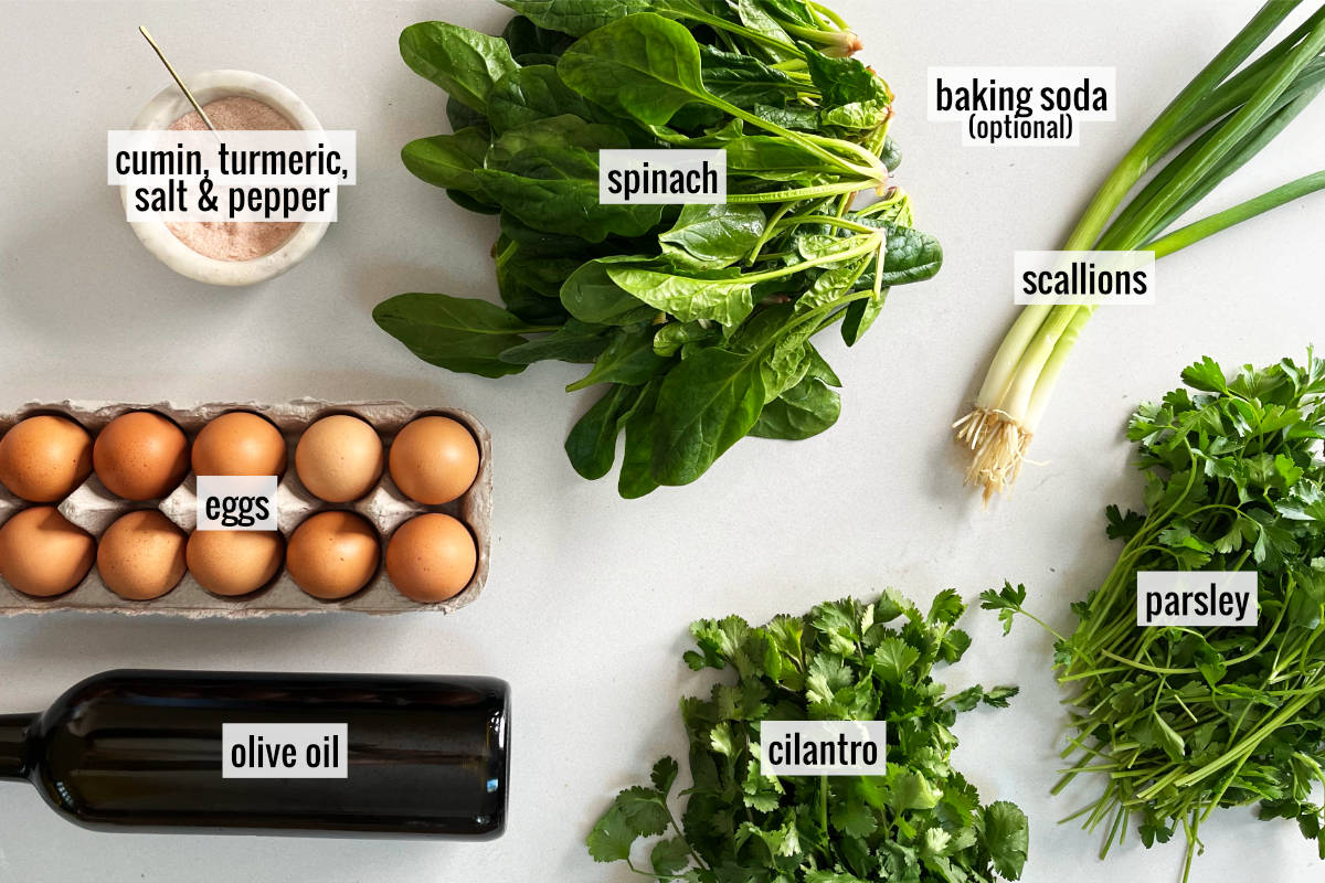 Ingredients to make kuku sabzi like eggs, spinach, and herbs.