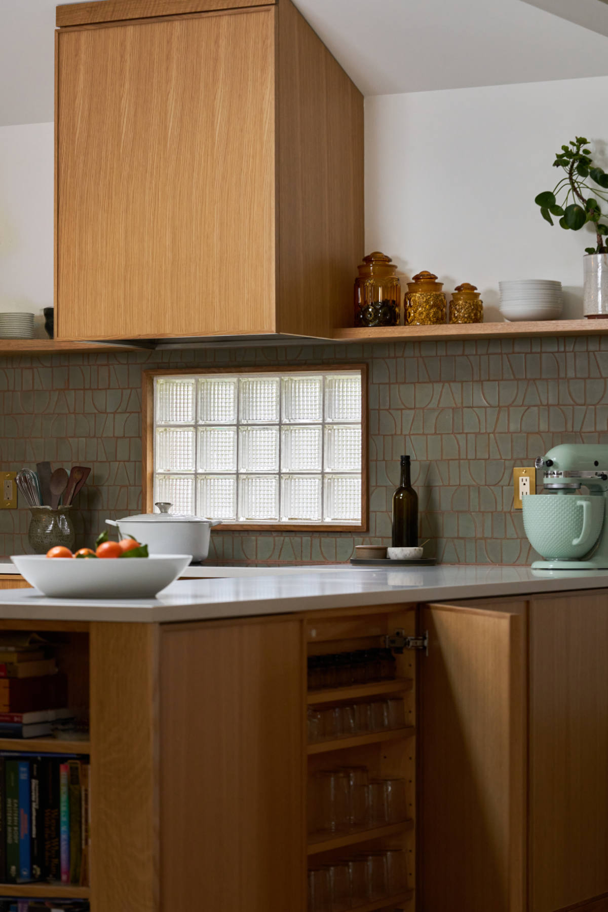 Wood kitchen with green backsplash.