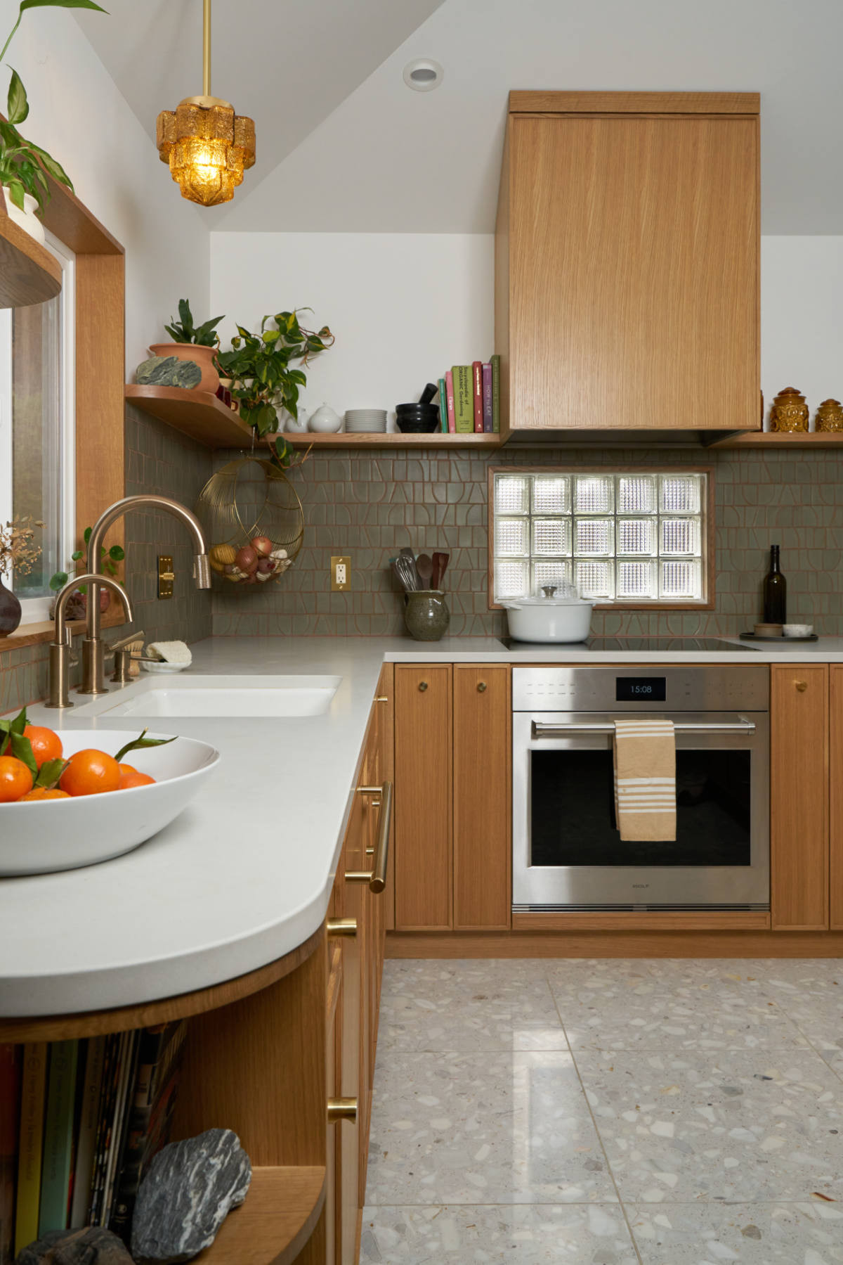 Kitchen with wood cabinets and glass block window.