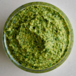 green pesto in a glass ramekin.