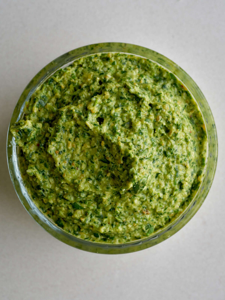 green pesto in a glass ramekin.