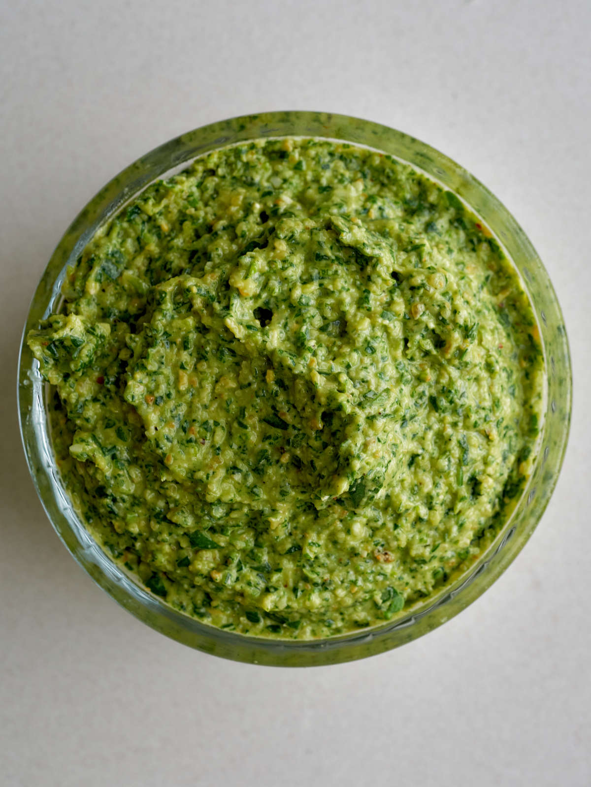 green pesto in a glass ramekin.