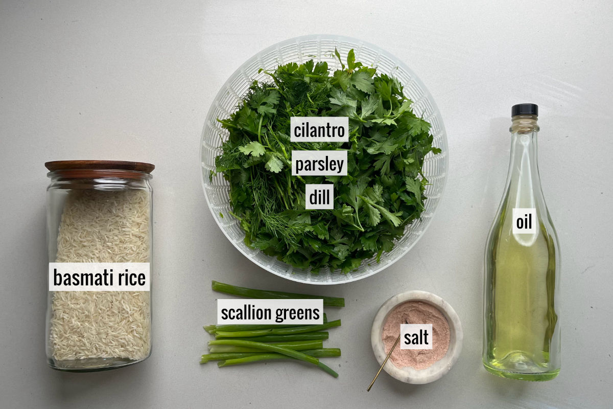 A large bowl of herbs next to a container of white rice, oil, and other ingredients to make herb rice.