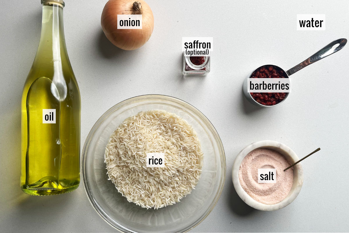 Oil, rice, saffron, an onion, barberries, and salt on a countertop.