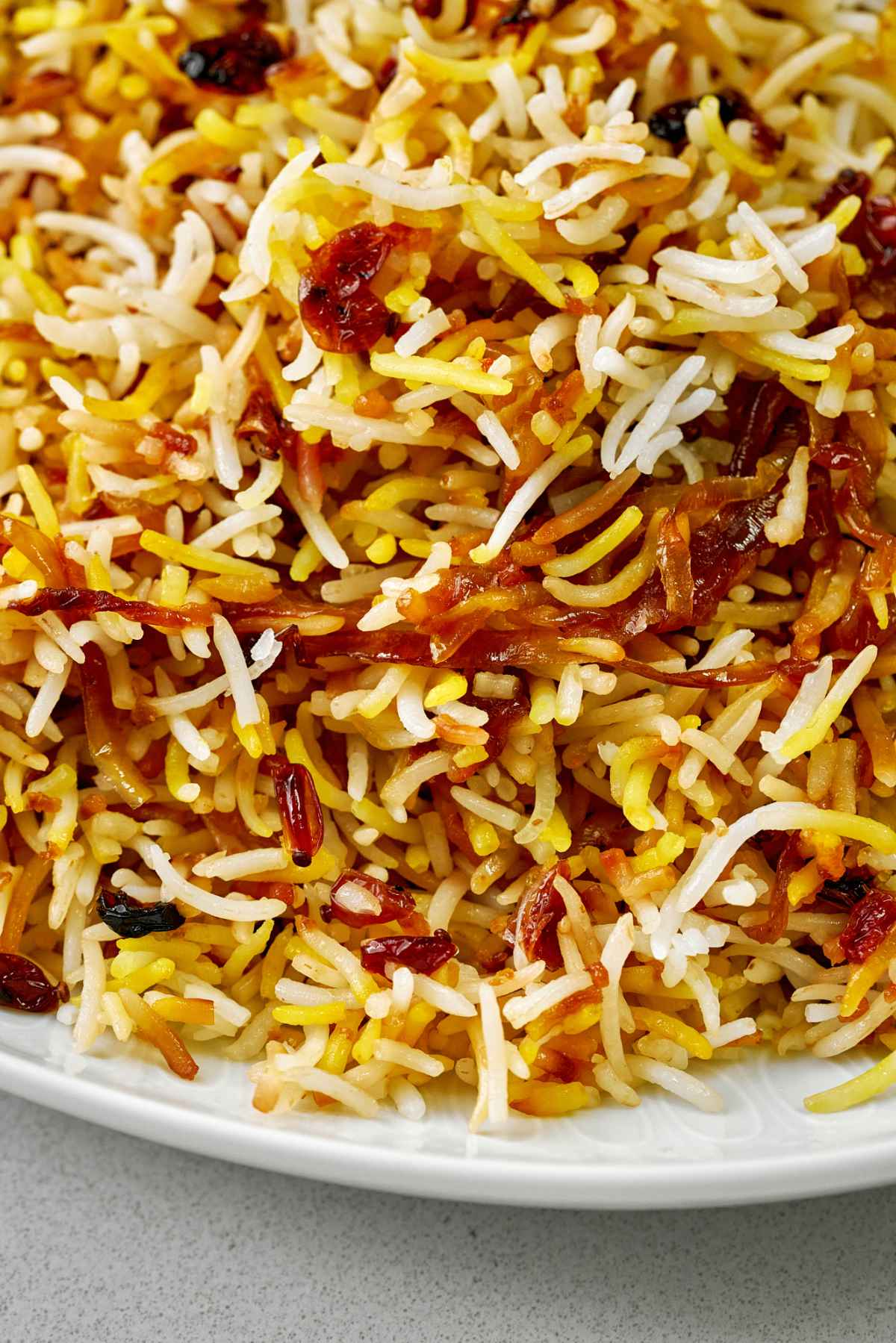 Close up of rice pilaf on a white plate.