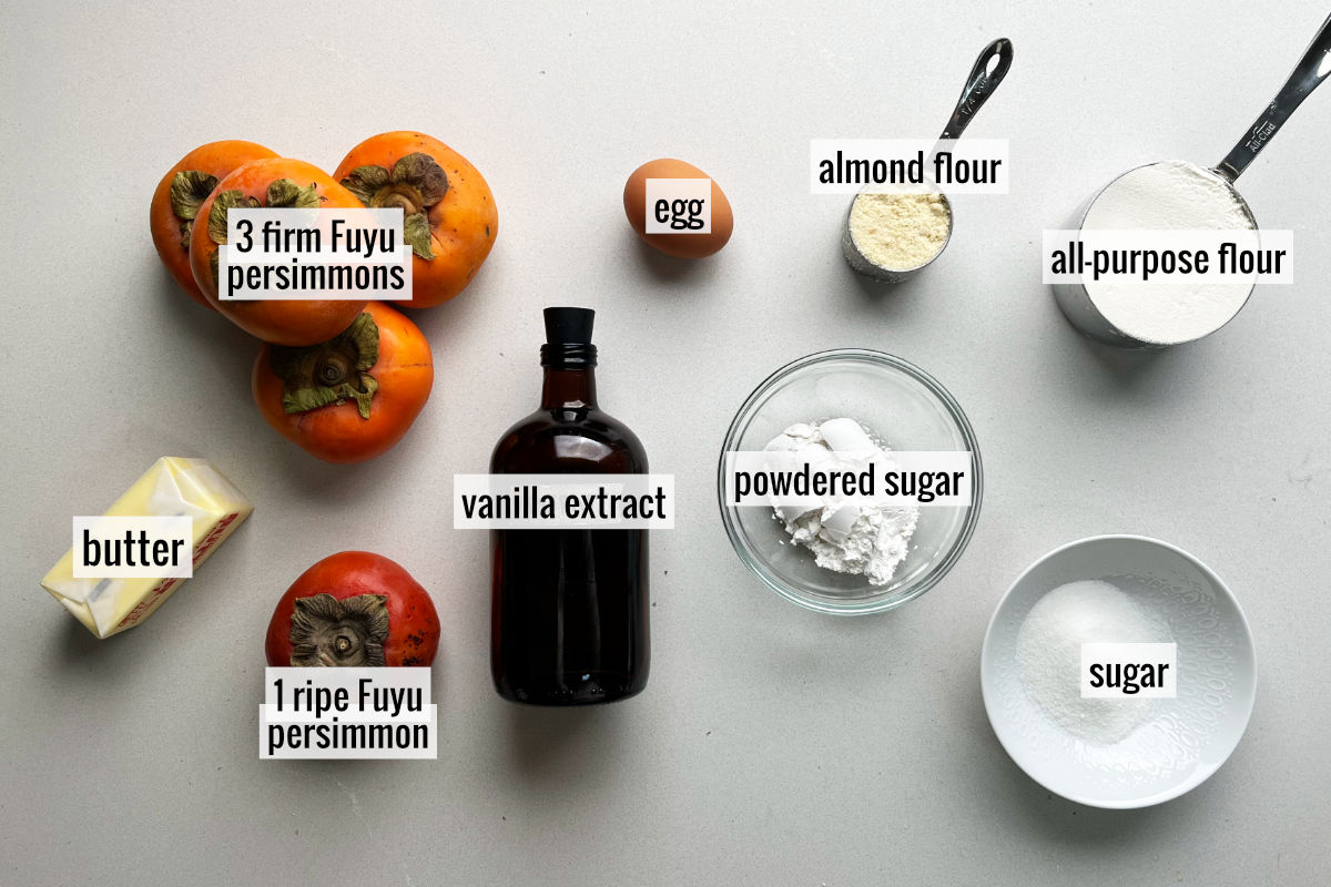 Persimmons and other labeled baking ingredients on a countertop.