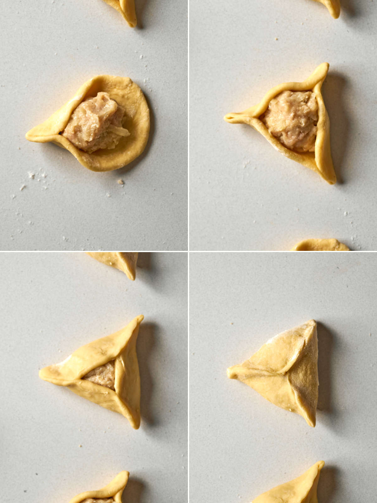 Folding triangular dumplings around a ball of ground chicken.