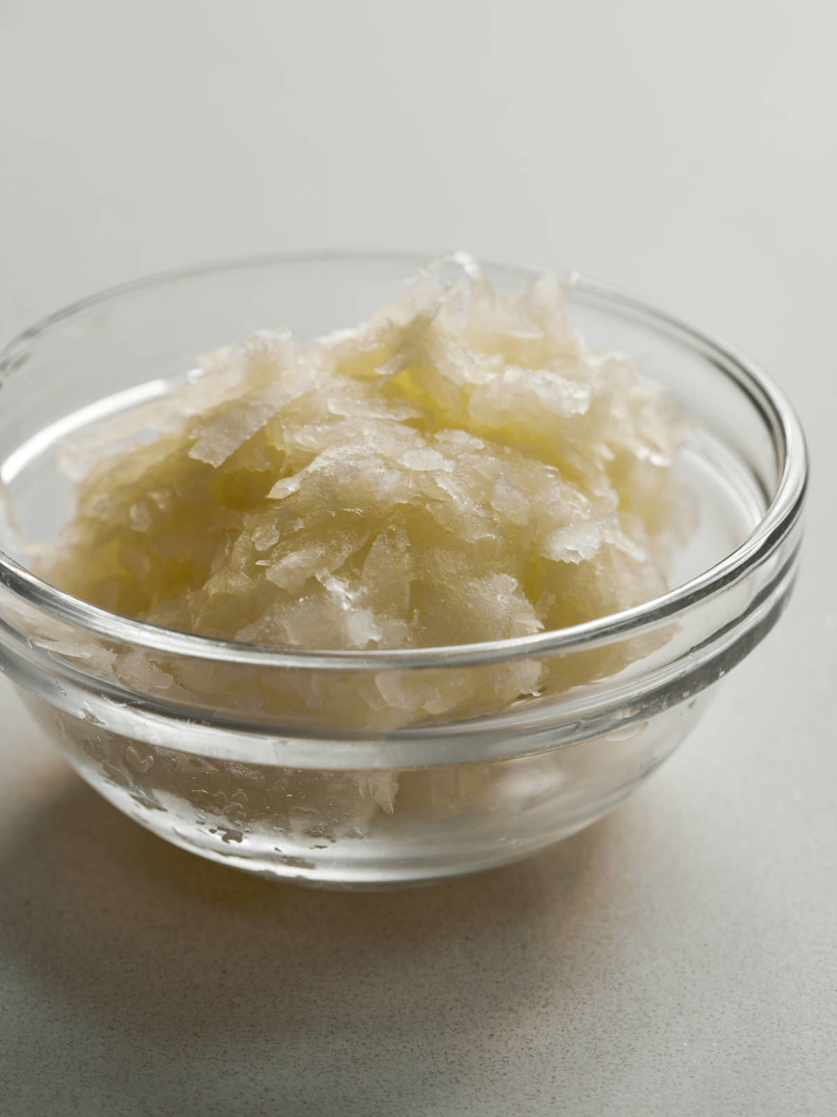 Grated onion in a small glass bowl.