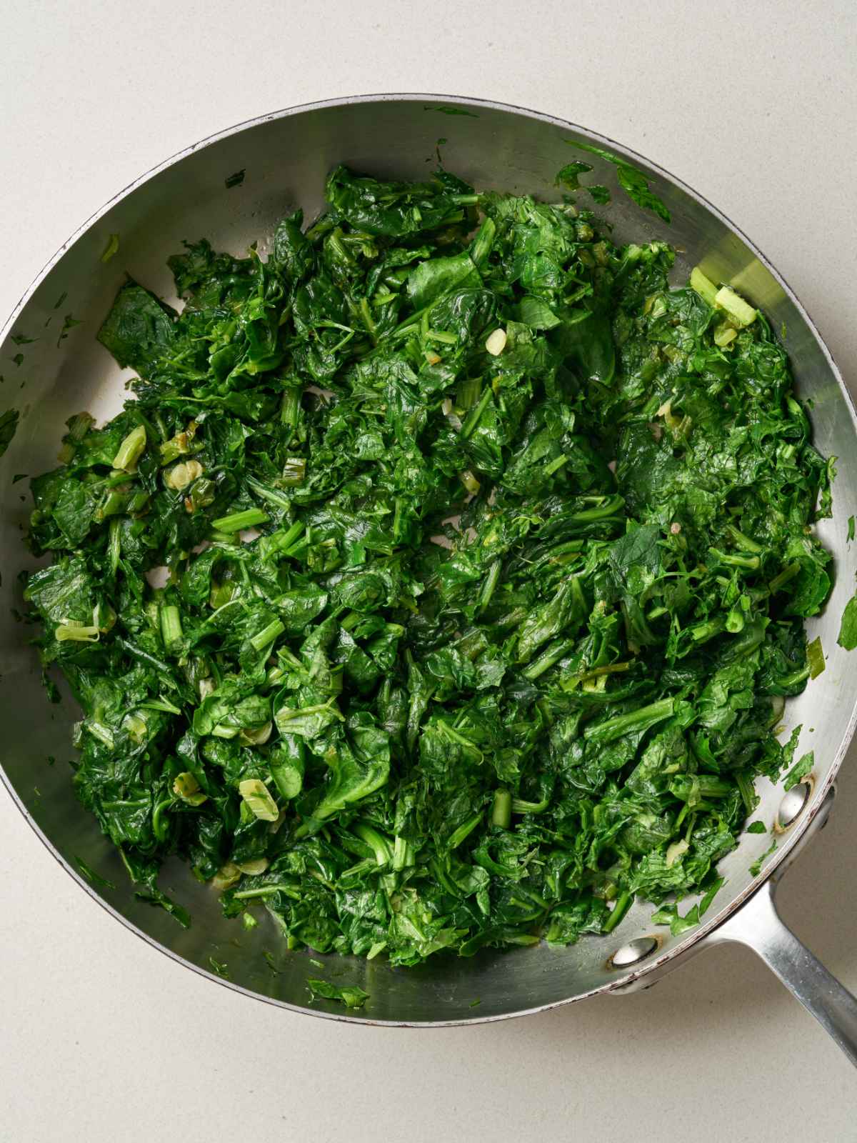 A pile of herbs that has been steamed and wilted by heat