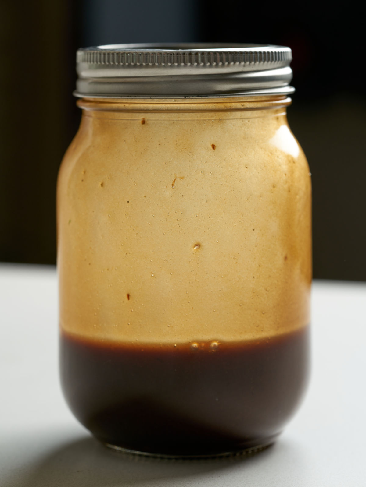 Salad dressing in a sealed mason jar.