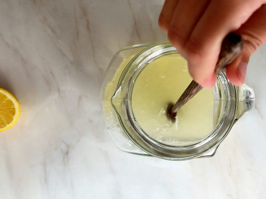 Stirring lemonade in a pitcher.