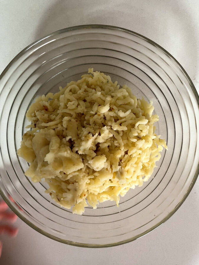 Milled potatoes in a glass bowl.