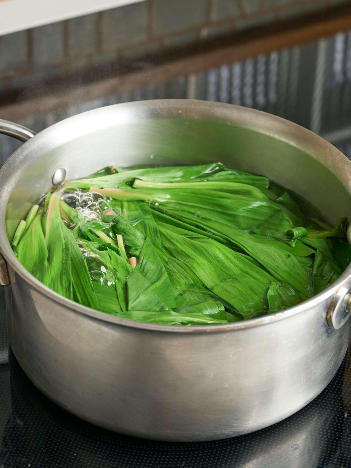 Ramp leaves and a large silver sauce pan of water