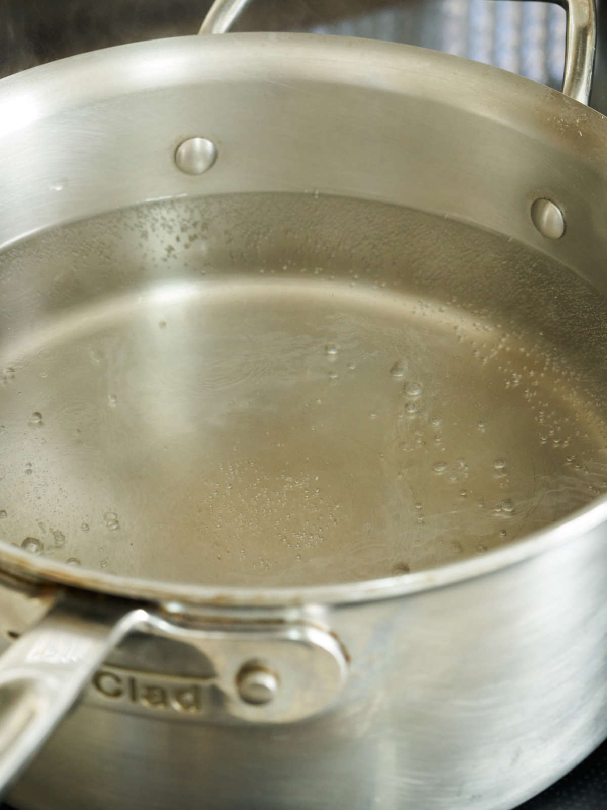 Water boiling in a large silver saucepan