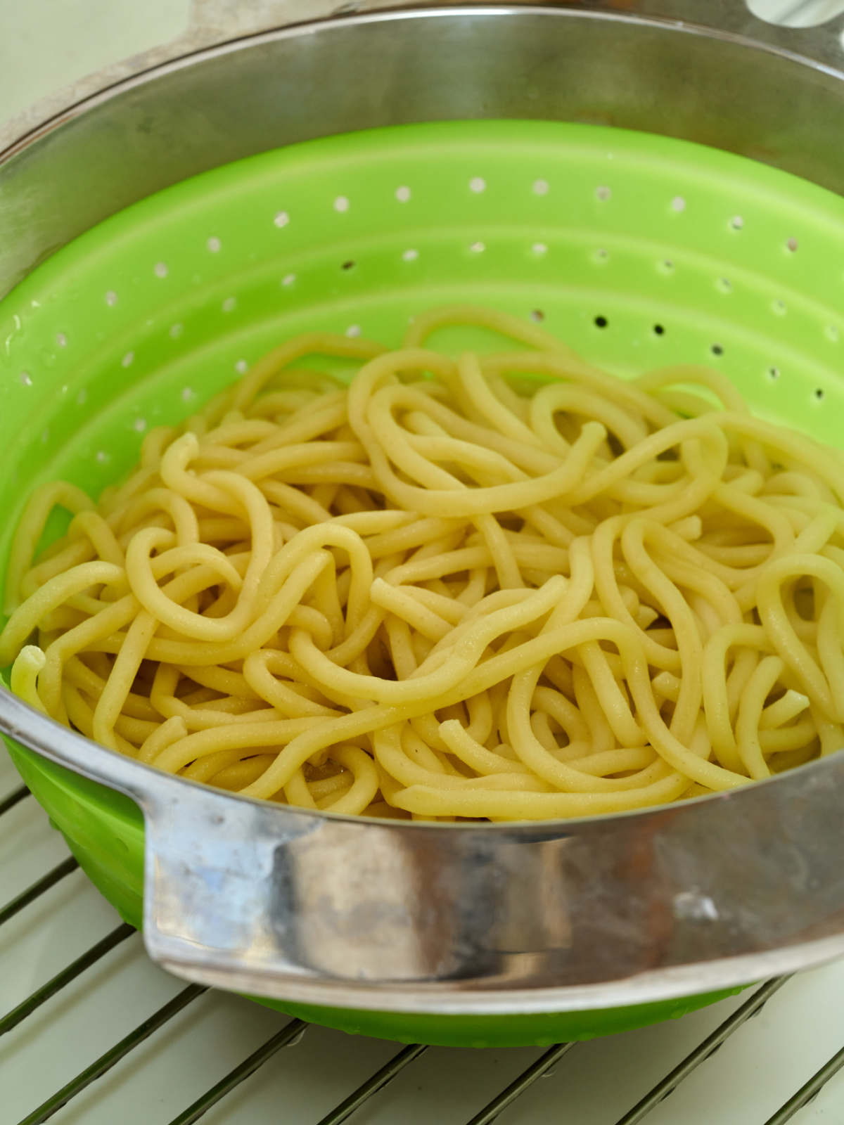 Pasta noodles in a pasta strainer