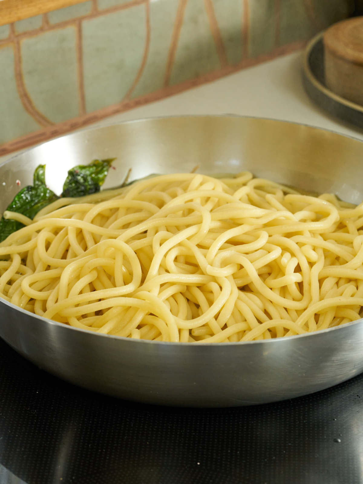 Pasta noodles in a large silver sauce pan