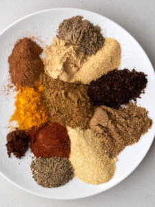 Segregated spices on a white plate.