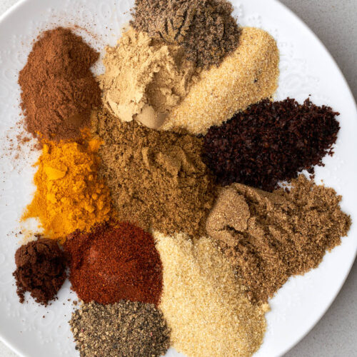 Segregated spices on a white plate.