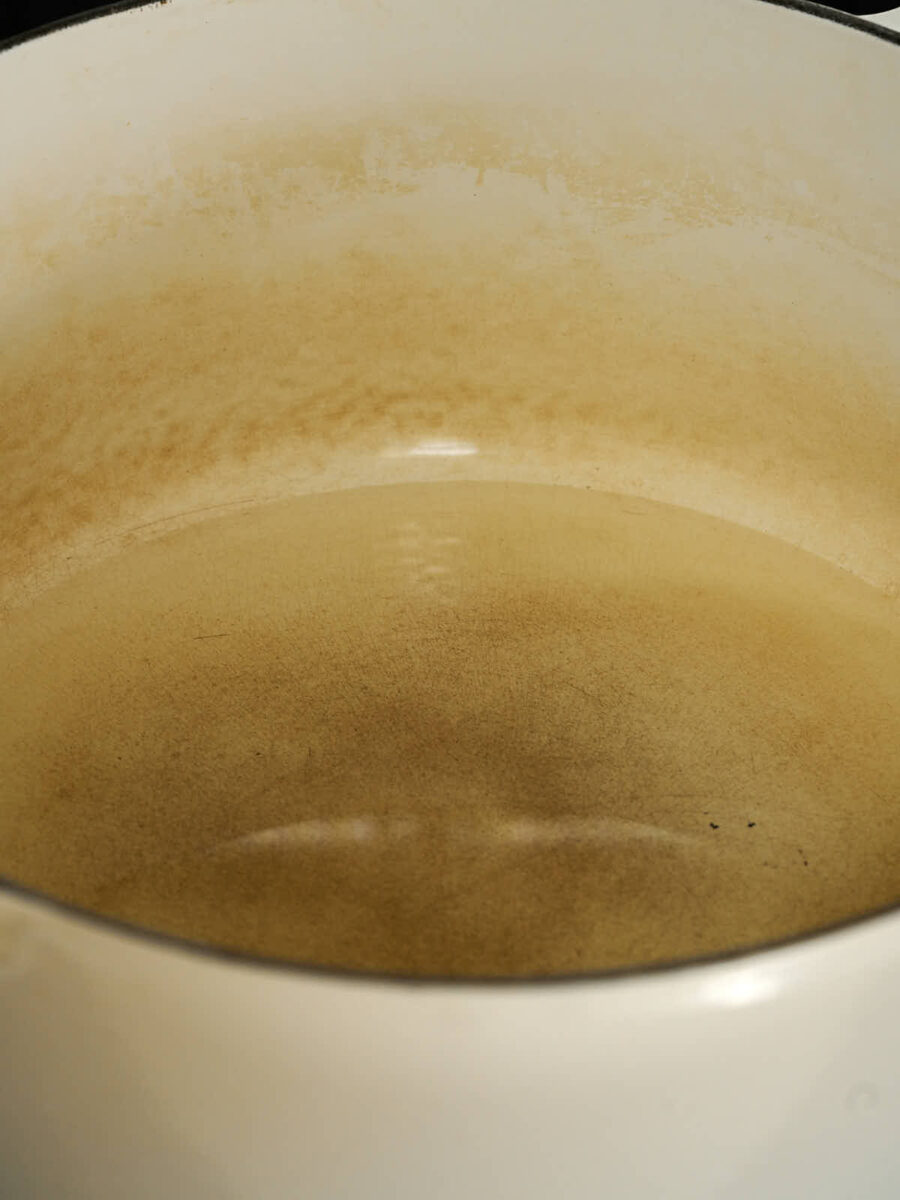 Oil heating up in the bottom of a large pot.