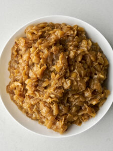 Caramelized onions in a large white bowl.