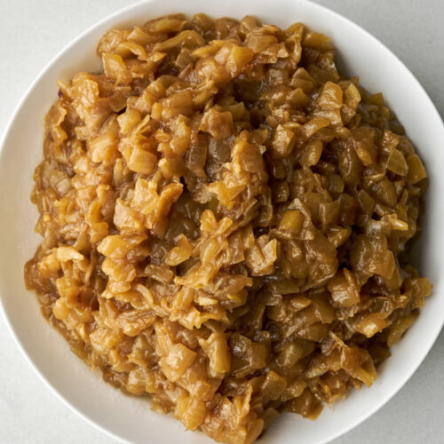 Caramelized onions in a large white bowl.